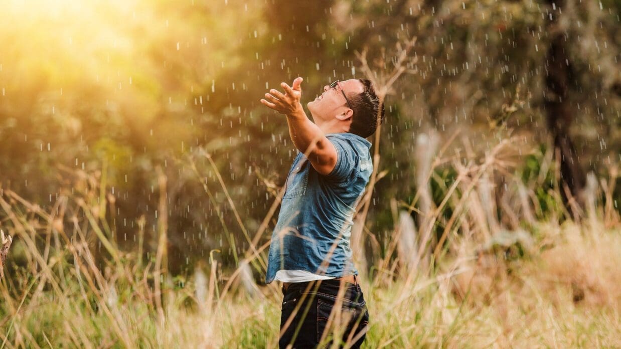 man singing in a field