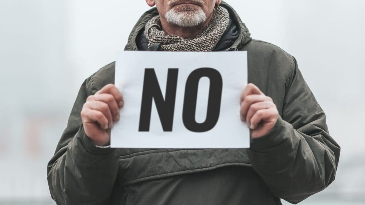 Dissenting activist. Senior man with placard - NO. Single picket.
