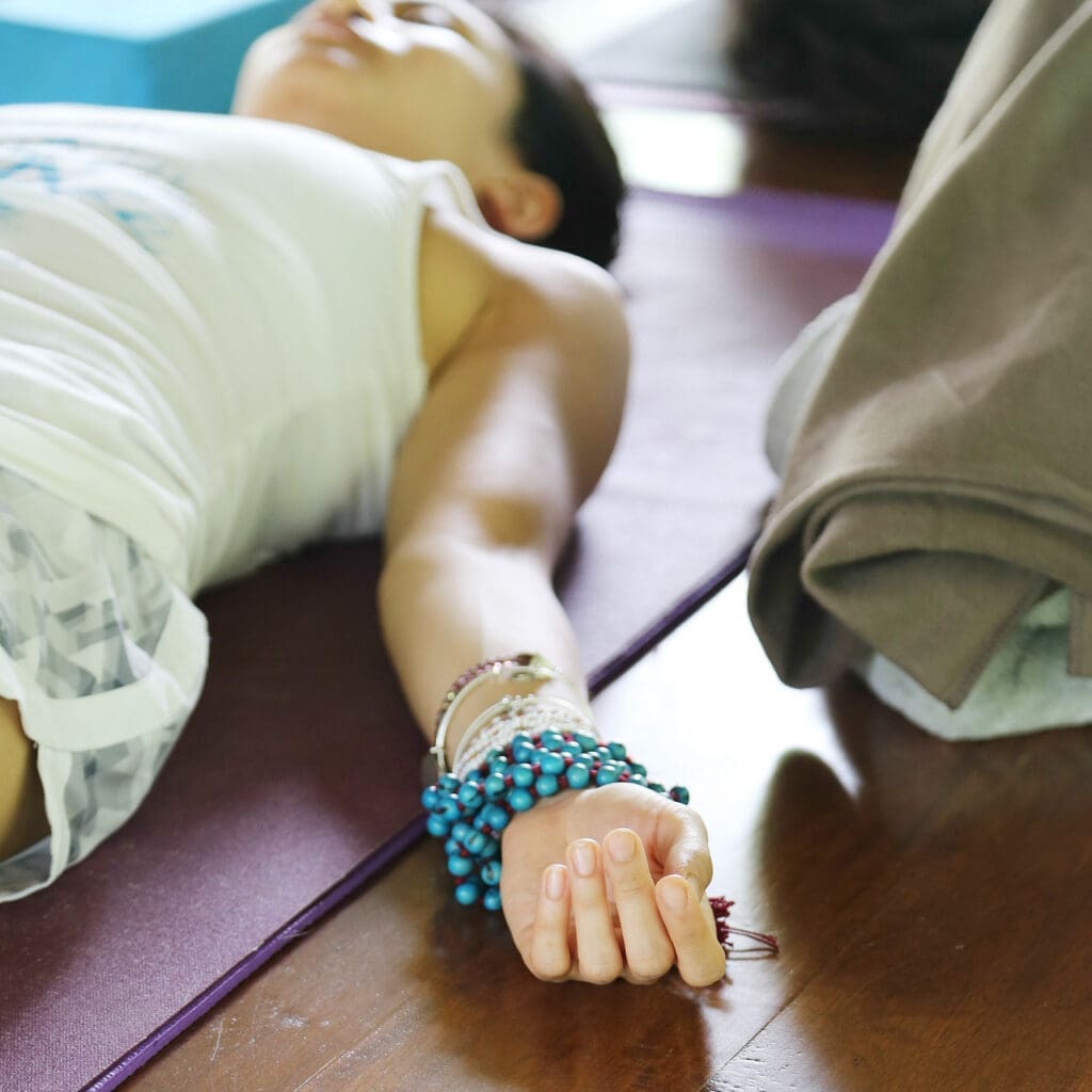 Woman practicing savasana.